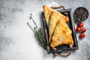 Central Asia Puff pastries with meat samosa, samsa. White background. Top view. Copy space photo
