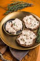 Toasts with Cod liver Spread pate on a plate. Orange background. Top view photo