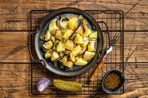 Kartoffelsalat - Traditional German potato salad. Wooden background. Top view photo
