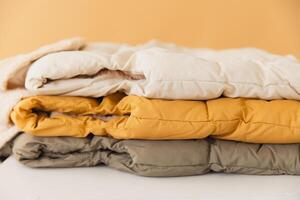 Stack of warm winter jackets creating cozy atmosphere photo