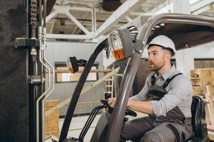 Builder driving forklift in modular building factory photo