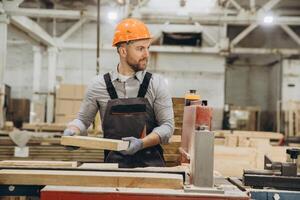 Carpenter working with wood in a factory for modular building photo