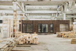 Workers building modular home in large warehouse photo