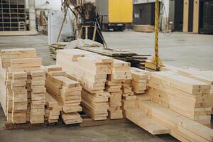 Stacks of lumber sit in a warehouse awaiting use in modular building industry photo