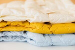 Stack of colorful winter jackets creating warmth and style photo