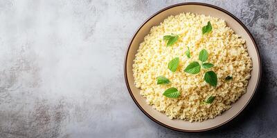 Couscous grains on a flat, round dish with minimal garnish, culinary photography photo