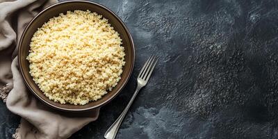 Quinoa arranged in a deep ceramic bowl, with visible grains and a basic fork beside it, food photography photo