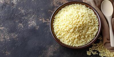 Couscous in a deep ceramic bowl with visible ingredients and a spoon, culinary photography photo