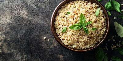 Quinoa neatly arranged in a deep, round ceramic bowl with visible grains and garnish, food photography photo
