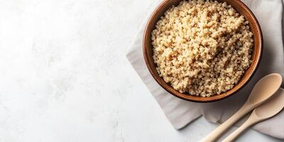 Quinoa serving in a wide, shallow dish, with a plain utensil placed next to it, culinary photography photo
