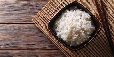 Sticky rice served in a compact square ceramic container on a table, photorealistic food photo