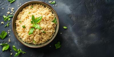 Quinoa neatly arranged in a deep, round ceramic bowl with visible grains and garnish, food setting photo