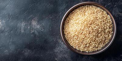 Quinoa neatly arranged in a deep, round ceramic bowl with visible grains and garnish, meal photography photo