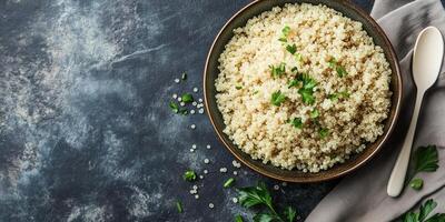 Quinoa serving in a wide, shallow dish, with a plain utensil placed next to it, meal photography photo