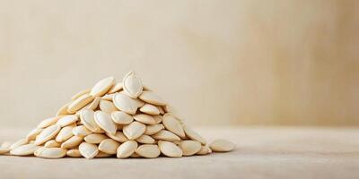 Small pile of pumpkin seeds displayed in a slightly irregular pattern, meal photography photo