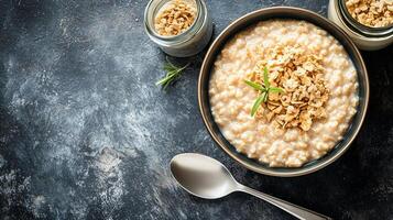 Hot cereal bowl steaming with a spoon and jar of toppings nearby, culinary photography photo