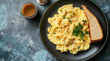 Scrambled eggs on a plate beside toast and a small container of condiments, culinary photography photo