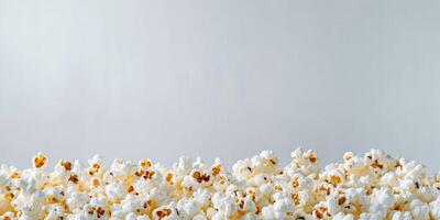 Piled buttered popcorn with popped kernels on a plain background, gastronomy photography photo