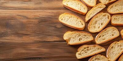 Close-up of sliced baguette pieces neatly arranged on wooden surface, food setting photo