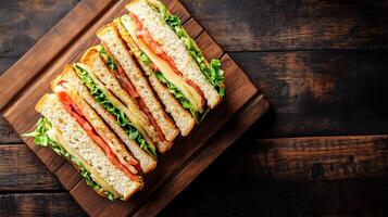 Top-down view of a club sandwich placed on a wooden serving board, meal photography photo