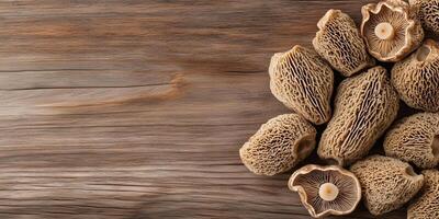 Sliced morel mushrooms arranged in a fan shape on a wooden surface, food setting photo