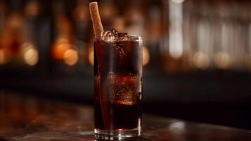 Highball glass showcasing a dark-colored drink with a piece of licorice resting on the rim, food photography photo