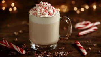Frothy beverage in a clear mug, surrounded by peppermint bark and candy canes, food setting photo