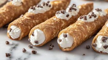 Group of cannoli displayed on a marble surface, with filling visible at each end, food setting photo