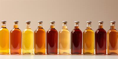 Group of kombucha bottles in varying shades of amber, neatly arranged in a straight line, food setting photo