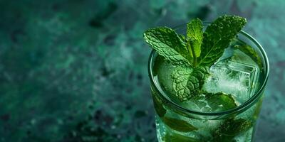 Highball glass with ice cubes, green beverage, and mint sprig, food setting photo
