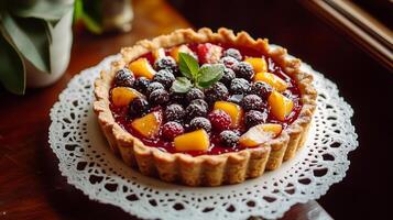 Tart with a crust and fruit topping, resting on a white doily on a platter, meal photography photo