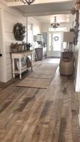A wood floor in a home with a chandelier photo