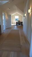 A hallway with a rug and a door photo