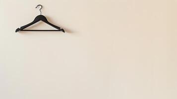 A black hanger on a white wall photo