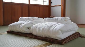 A pair of folded towels on a bed photo