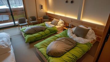 A couple of beds in a room with a window photo