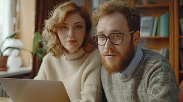 A man and woman looking at a laptop photo