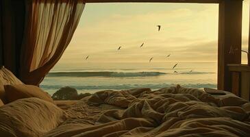 A bed with a window overlooking the ocean photo