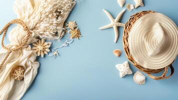 A hat, shells and other items are arranged on a blue background photo