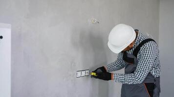 Indian electrician installing a wall socket video