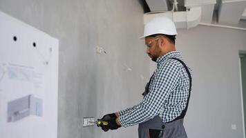 Indian electrician installing a wall socket video