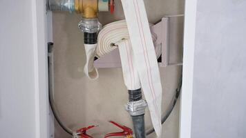 Fire extinguishers and hydrant installed in a metal cabinet on the wall at office in case of emergency video