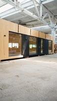 Prefabricated modular mobile wooden house at construction site. Vertical video