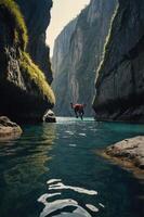 A serene canyon scene with a person kayaking in clear waters surrounded by steep cliffs. photo