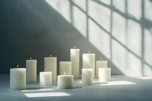 Burning White Candles on a Grey Surface With Shadow Patterns photo