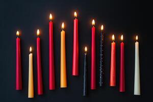 Assortment of Burning Candles on a Black Surface photo
