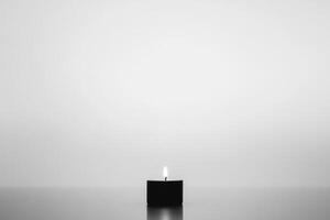 A Single Lit Candle on a Smooth Surface photo