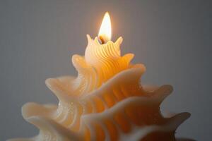 A Close-up of a Burning, Wavy, White Candle photo
