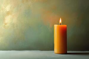A Single Lit Candle Against a Green and Yellow Background photo
