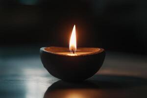 A Single Candle Flame Glowing in a Clay Diya photo